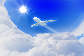 aerospace industry image with a plane flying in the clouds